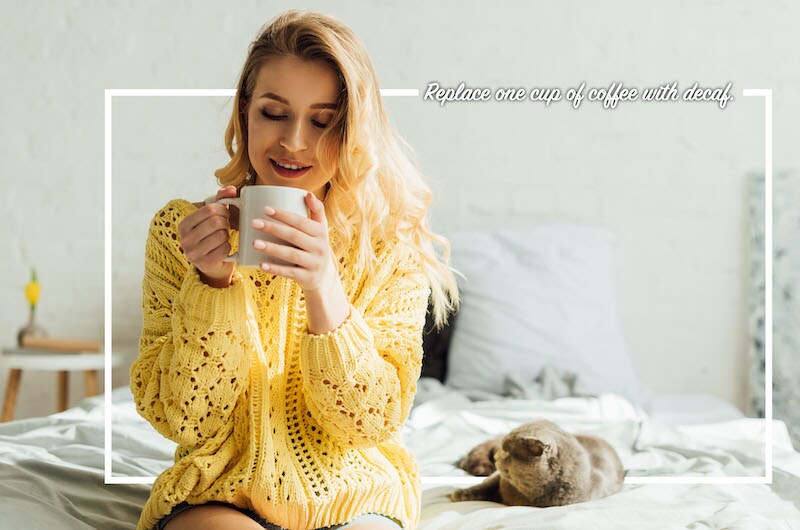 woman enjoying coffee on the bed