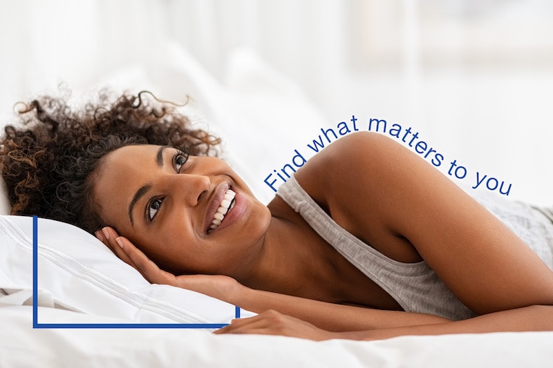 woman happily laying in bed