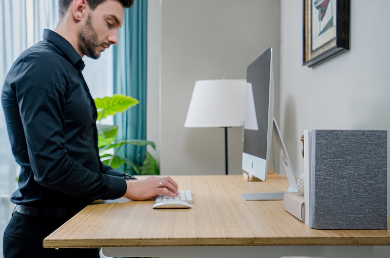 man using modish standing desk