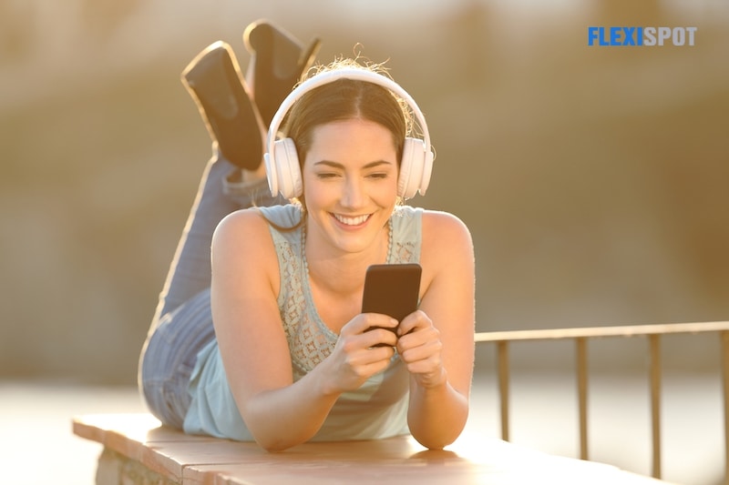 Happy girl listening to music browsing mobile phone content