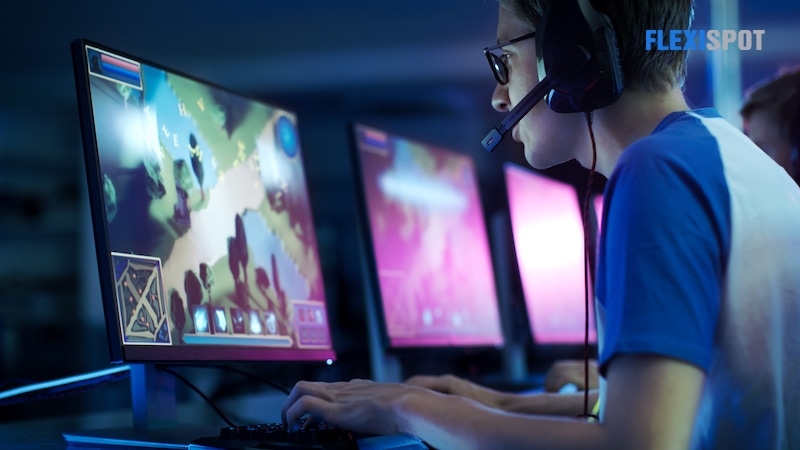 The team of professional e-sports players play Mmorpg/strategy video games in competition, and online game competitions. They talk to each other into the microphone. Neon lights that look cool on the stage.