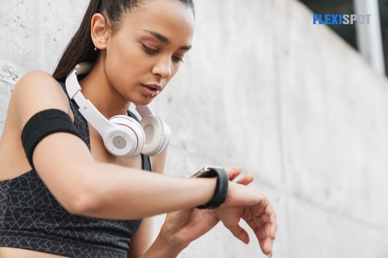Partial view of girl using fitness tracker
