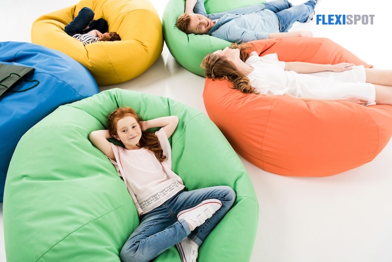 family resting on beanbag chairs
