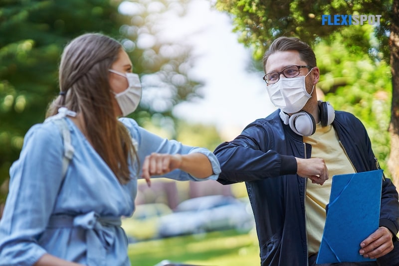 2 people wearing face mask while communicating 