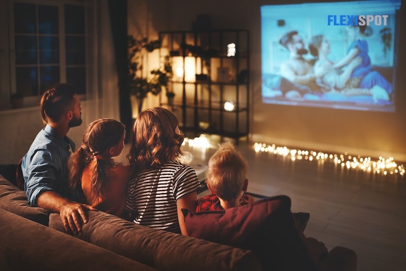 Family mother father and children watching projector, TV, movies