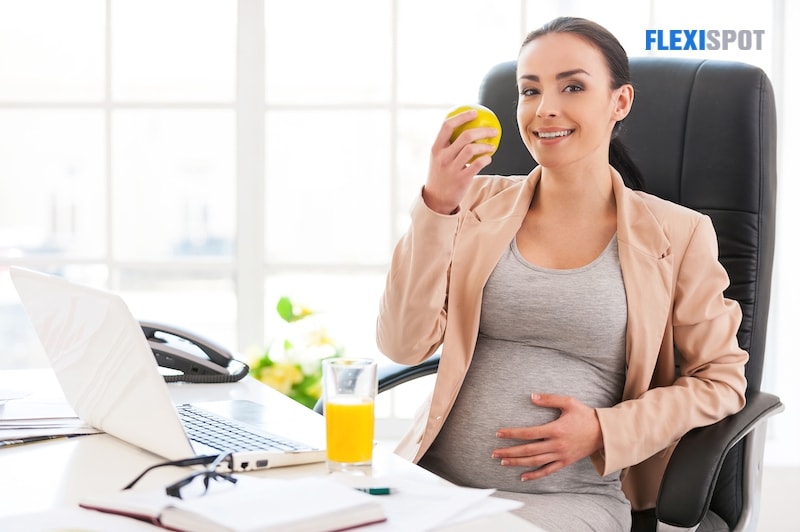 pregnant woman sitting in office