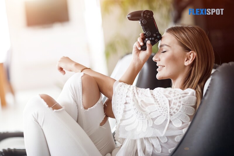Smiling woman playing video games at home, with joystick