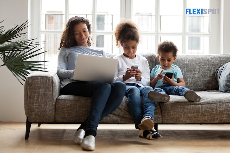 Black mom and kids use laptop phones to indulge in devices