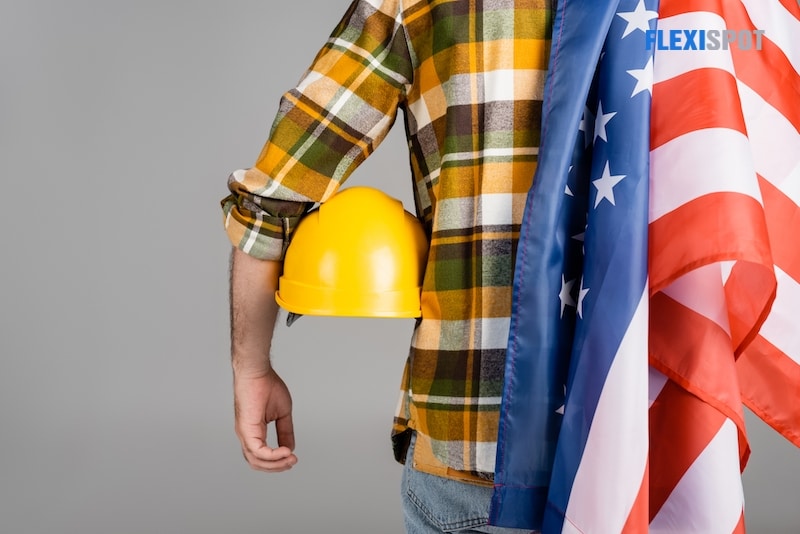 Back view of cropped workman with hardhat and usa flag isolated on grey, labor day concept