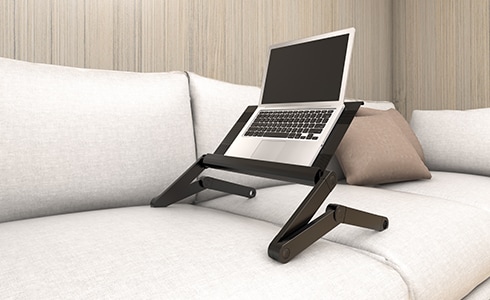 If you want to break away from your desk, you can work from your couch with a laptop riser. It does a nice job of holding your laptop even if you adjust it to different angles and height.